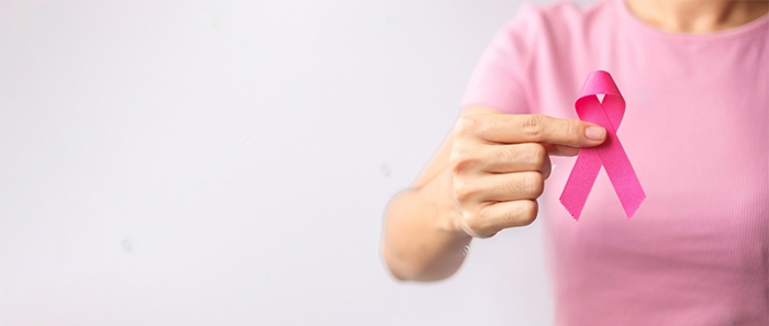 Pink October Breast Cancer Awareness month, woman hand hold pink Ribbon and wear shirt for support people life and illness. National cancer survivors month, Mother and World cancer day concept